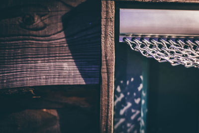 Close-up of metallic chain on wood at home