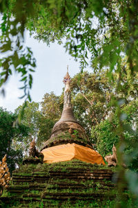 Low angle view of statue against trees