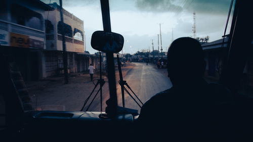 Silhouette of vehicles on street in city