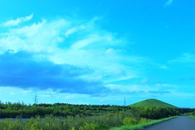 Scenic view of landscape against blue sky