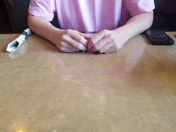 Midsection of man sitting on table