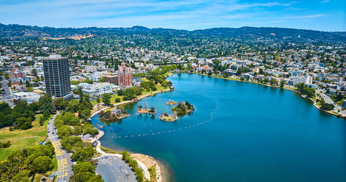 High angle view of townscape by sea against sky