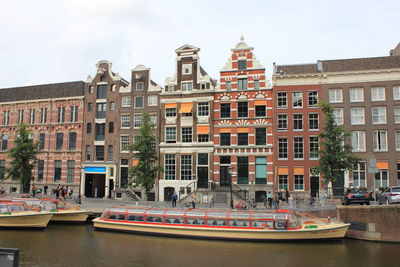 Amsterdam canal view, pleasure boats and beautiful old buildings