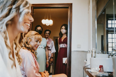 Bride and bridesmaid preparing for wedding ceremony