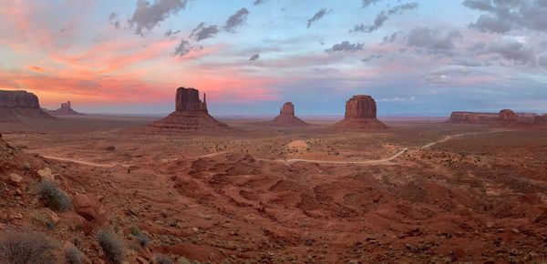 Panoramic view of desert against sky during sunset