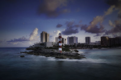 Scenic view of sea and buildings against sky