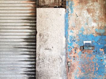 Rusty weathered door by closed store