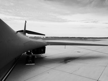 Airplane on airport runway against sky