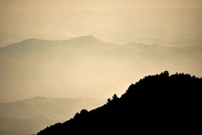 Scenic view of silhouette mountains against sky