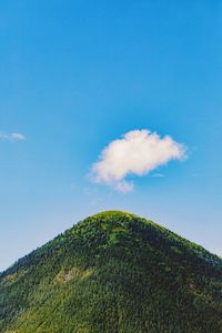 Low angle view of green mountain against sky