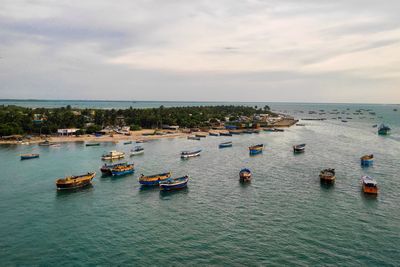 Boats in sea against sky