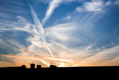 Silhouette of built structure at sunset