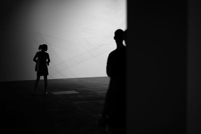 Silhouette people in corridor