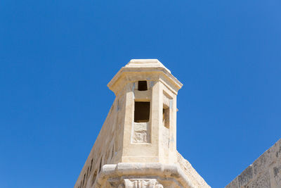 Low angle view of temple against clear blue sky