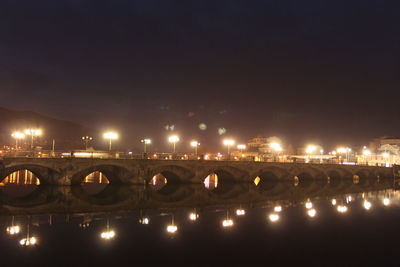 Illuminated burgo bridge over lerez river against sky at night