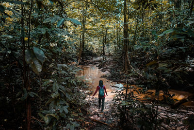 Woman walking in forest