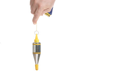 Close-up of hand holding umbrella against white background