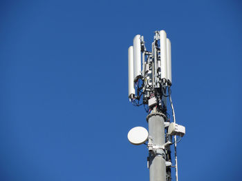 Telephone antenna on blue sky background