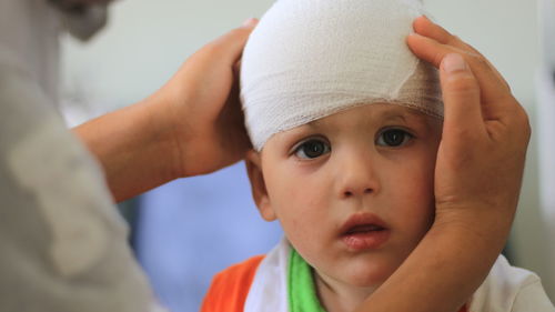 Portrait of cute boy with bandage on head