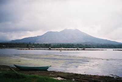 Scenic view of calm lake against mountain range