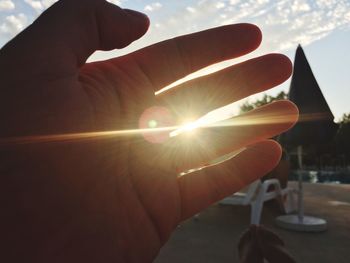 Cropped image of hand holding sun
