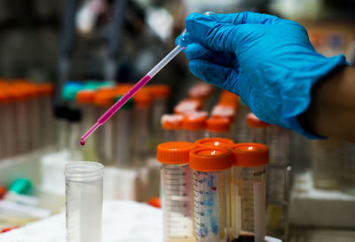 Cropped hand examining in laboratory