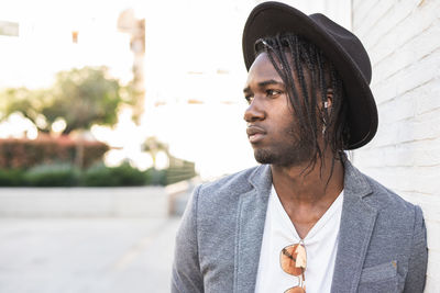 Young man looking away in city