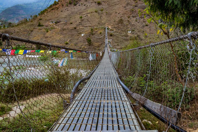 Footbridge over footpath amidst trees