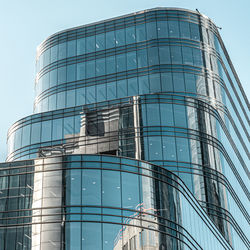 Low angle view of modern building against clear blue sky