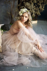 A young blonde in an airy tulle pink dress. spring portrait of a woman.