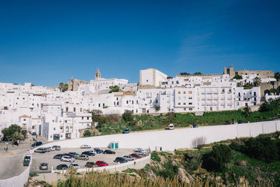 High angle view of residential district against clear blue sky