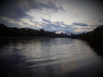 Scenic view of river against sky at sunset