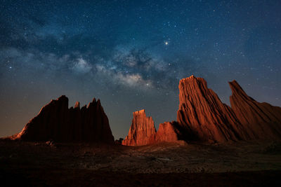 Rock formations against sky at night