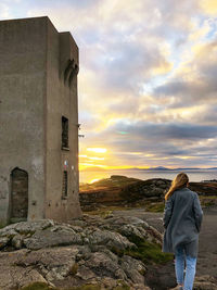 Rear view of woman looking at sunset