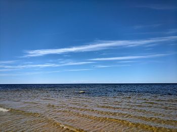 Scenic view of sea against blue sky