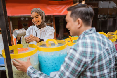 Side view of woman holding drink