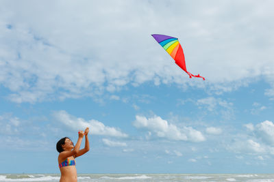 Rear view of woman holding umbrella