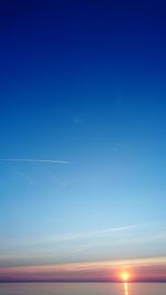 Scenic view of vapor trail against blue sky