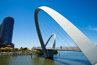 Low angle view of bridge against blue sky