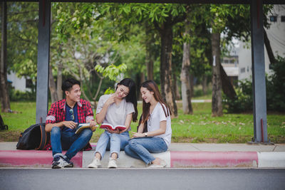 Rear view of people sitting outdoors