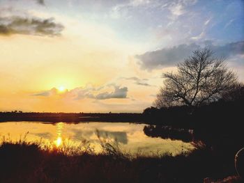 Scenic view of lake against sky during sunset