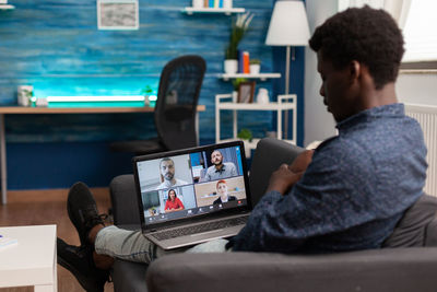 Businessman talking on video conference at home