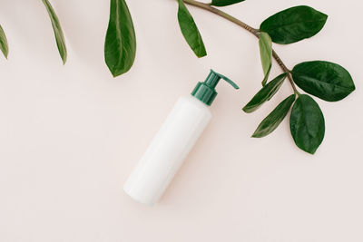 Natural home cosmetics in recyclable plastic bottles and cans on a beige background. flat lay