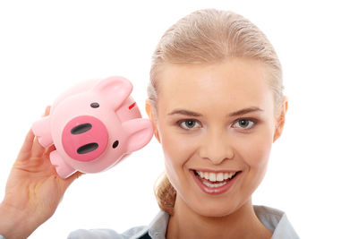 Close-up portrait of a smiling young woman over white background