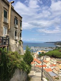 High angle view of townscape by sea against sky