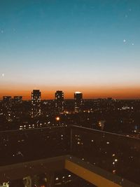 High angle view of illuminated buildings against sky at night