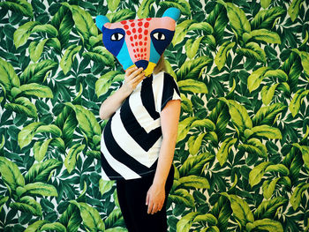 Woman holding animal mask