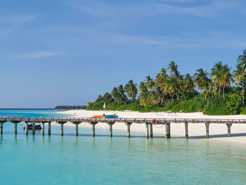 Scenic view of swimming pool by sea against sky