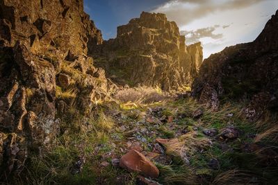 Rock formations on landscape against sky