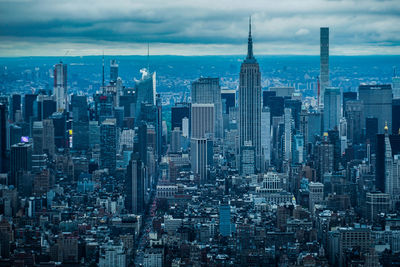 Aerial view of modern buildings in city against sky